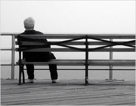 Lonely man sitting on a bench